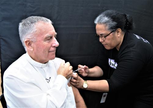 Cardinal John vaccinated by Pacific Navigator Nurse Alisa Kokea Logo 9 June